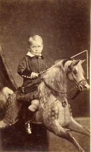 Young Boy with Whip on Rocking Horse